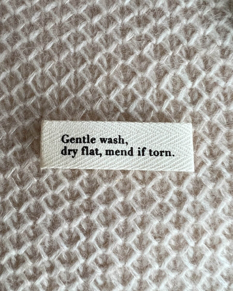 Gentle wash, dry flat, mend if torn.